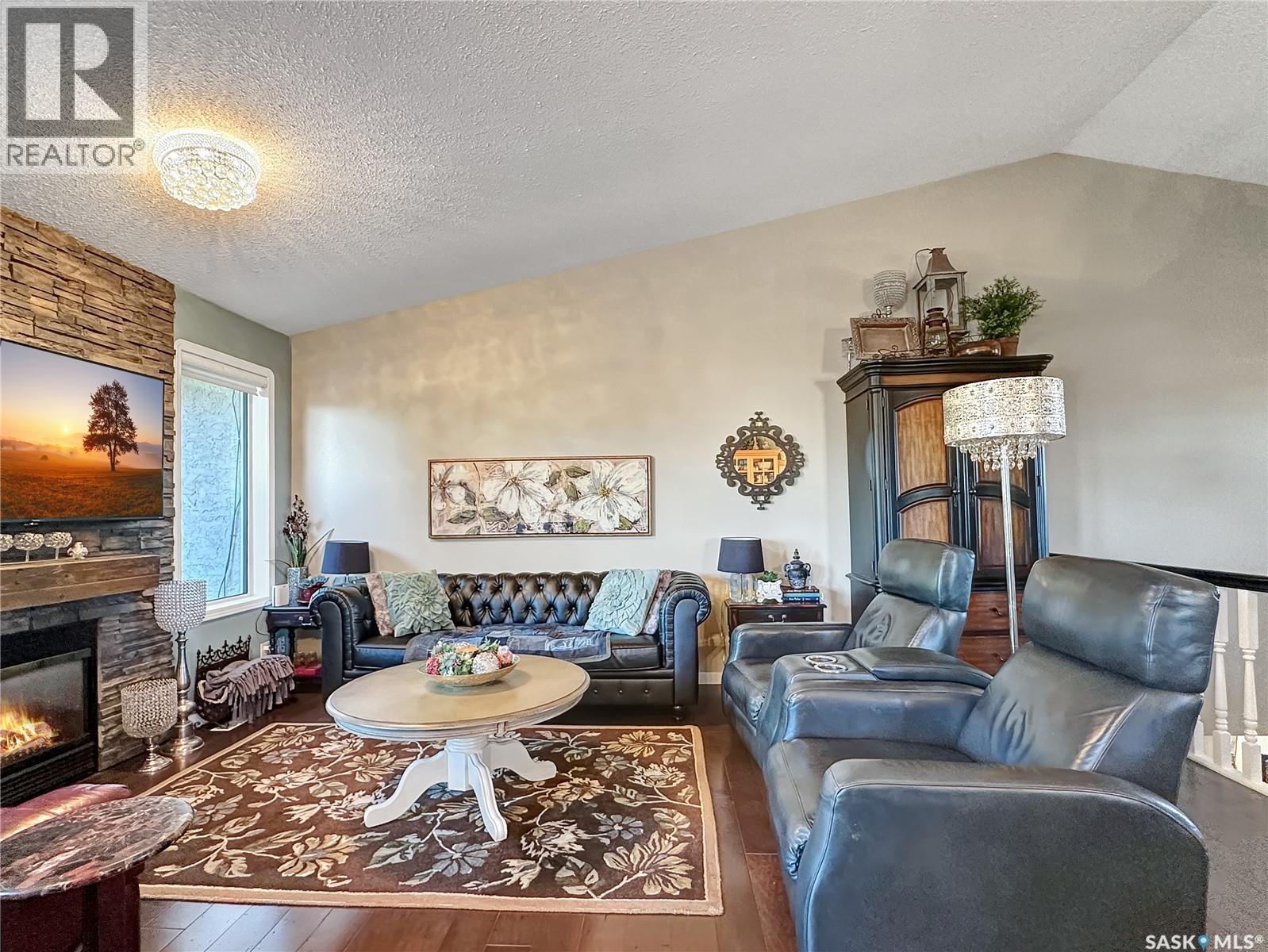 110 Sunset Crescent, Balcarres, SK - Indoor Photo Showing Living Room With Fireplace