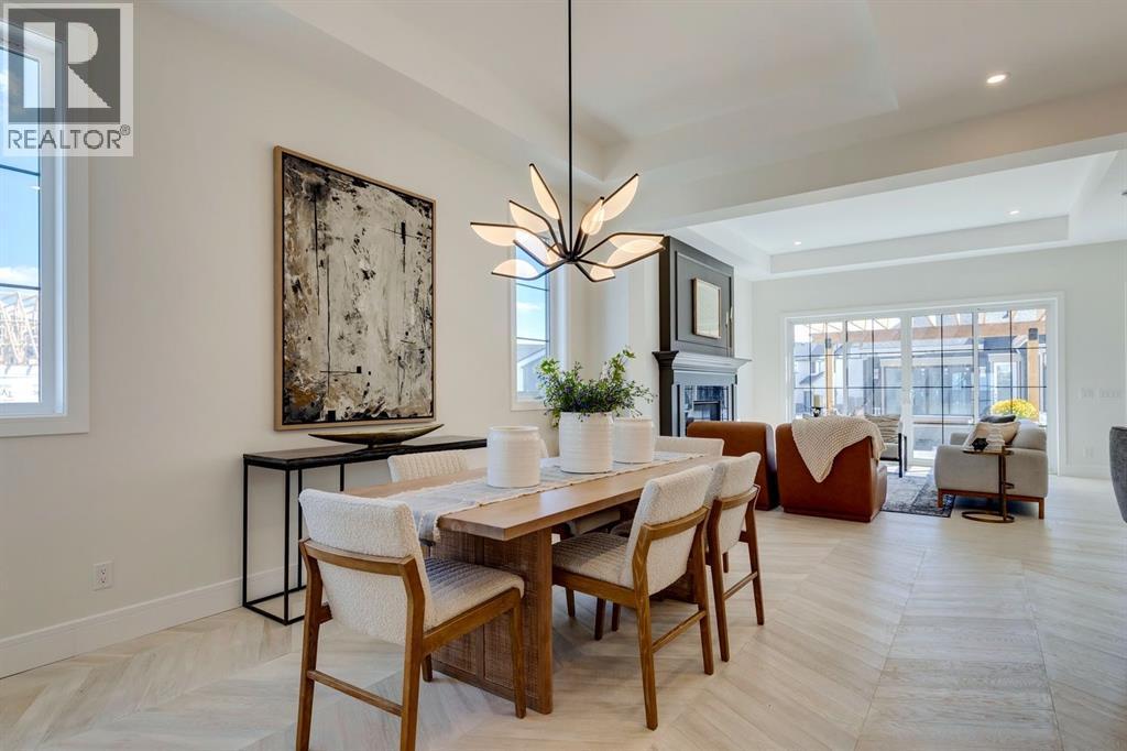 11 Normandy Lane Sw, Calgary, AB - Indoor Photo Showing Dining Room With Fireplace