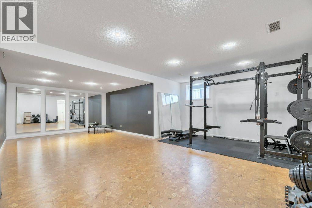 360 Parkmere Green, Chestermere, AB - Indoor Photo Showing Gym Room