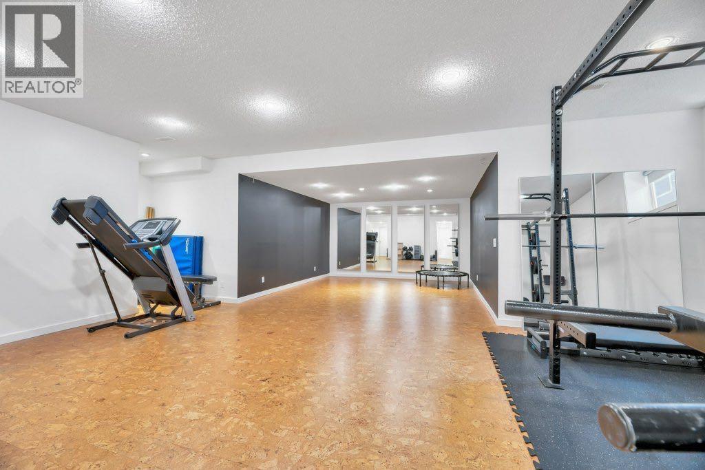 360 Parkmere Green, Chestermere, AB - Indoor Photo Showing Gym Room