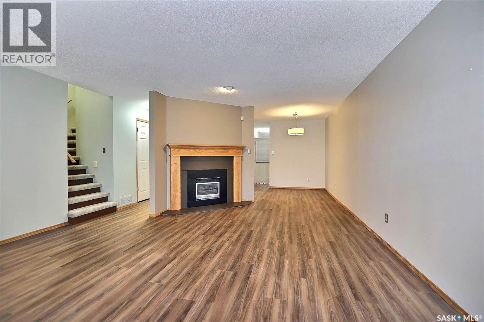 25 2338 Assiniboine Avenue E, Regina, SK - Indoor Photo Showing Living Room With Fireplace