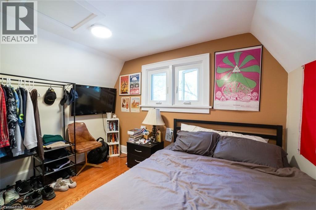 Bedroom with light wood-style flooring, vaulted ceiling, and attic access - 41 Paradise Road S, Hamilton, ON - Indoor Photo Showing Bedroom