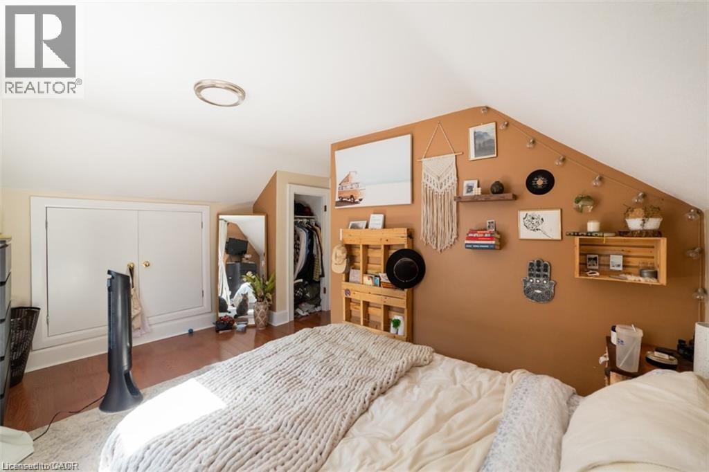 Bedroom featuring lofted ceiling, wood finished floors, and a walk in closet - 41 Paradise Road S, Hamilton, ON - Indoor Photo Showing Bedroom