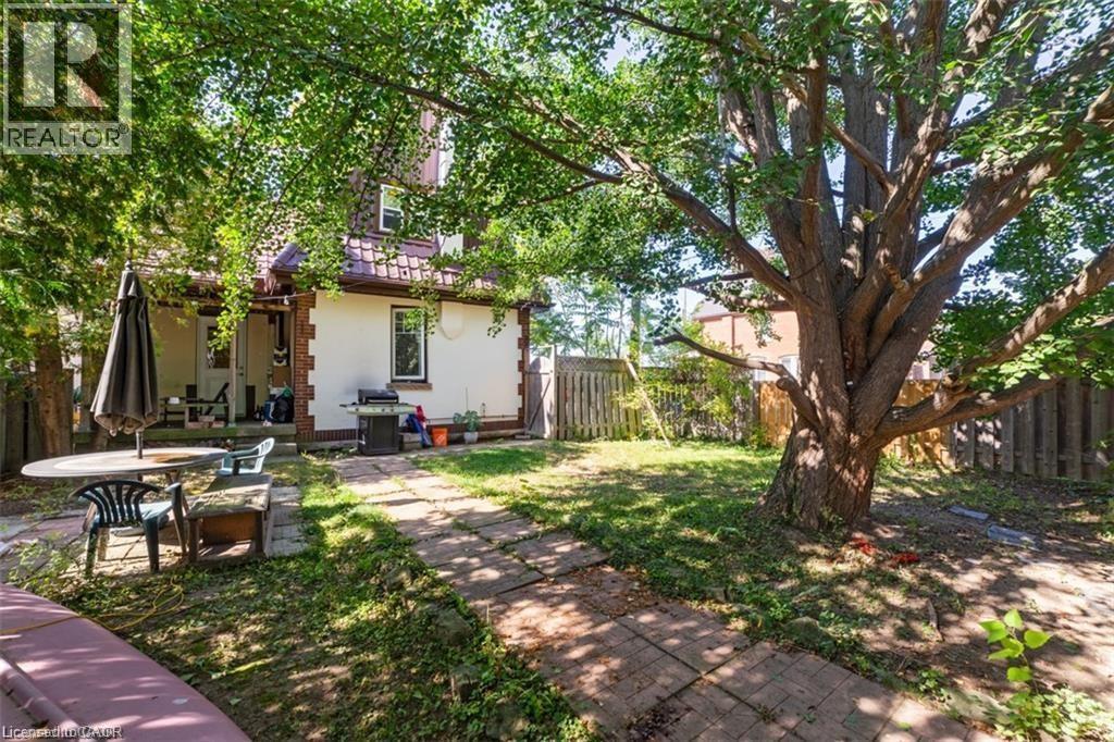 Back of property with a patio, a fenced backyard, and brick siding - 41 Paradise Road S, Hamilton, ON - Outdoor