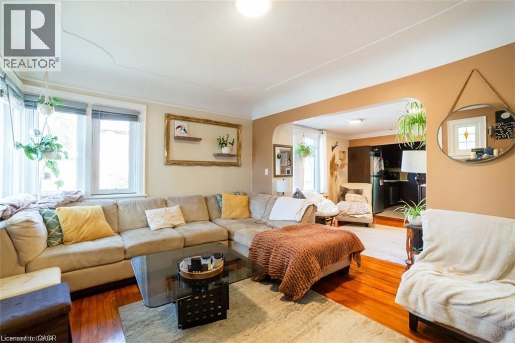 Living area featuring wood finished floors and arched walkways - 41 Paradise Road S, Hamilton, ON - Indoor Photo Showing Living Room