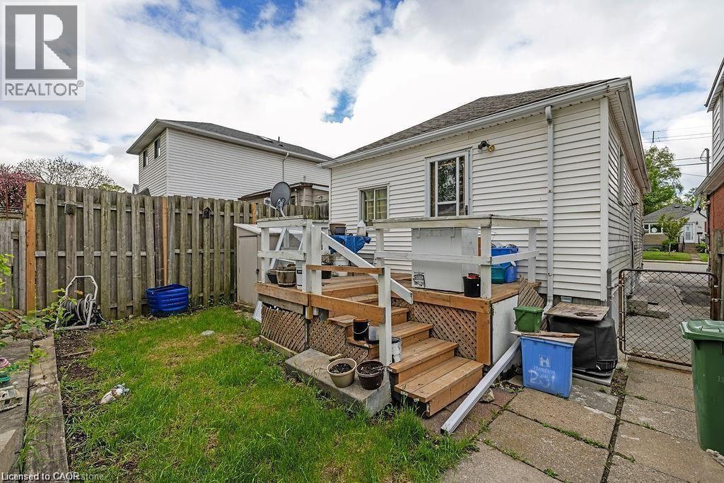 Rear view of house with a fenced backyard, a gate, a deck, and roof with shingles - 201 East 23Rd. Street, Hamilton, ON - Outdoor With Deck Patio Veranda With Exterior