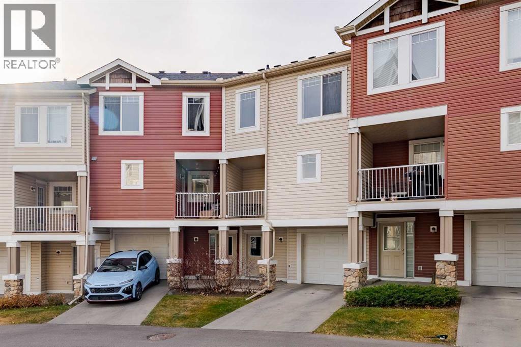 back alley with access to the garage - 122 Panamount Drive Nw, Calgary, AB - Outdoor With Facade