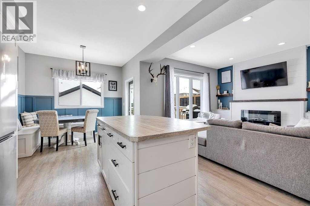 85 Reynolds Road, Sylvan Lake, AB - Indoor Photo Showing Living Room With Fireplace