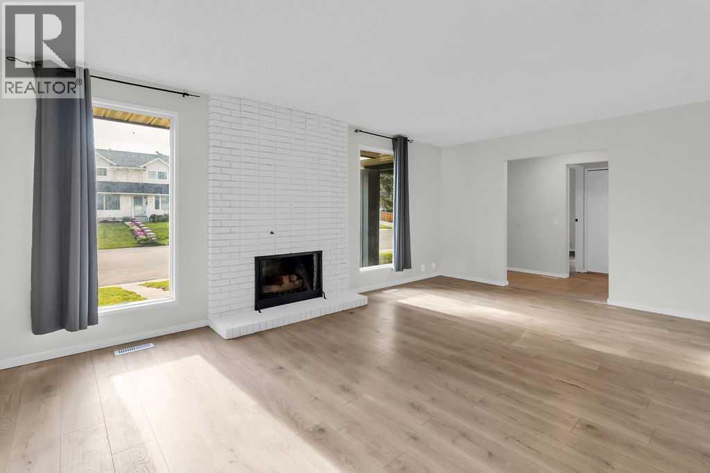 10 Radcliffe Crescent Se, Calgary, AB - Indoor Photo Showing Living Room With Fireplace