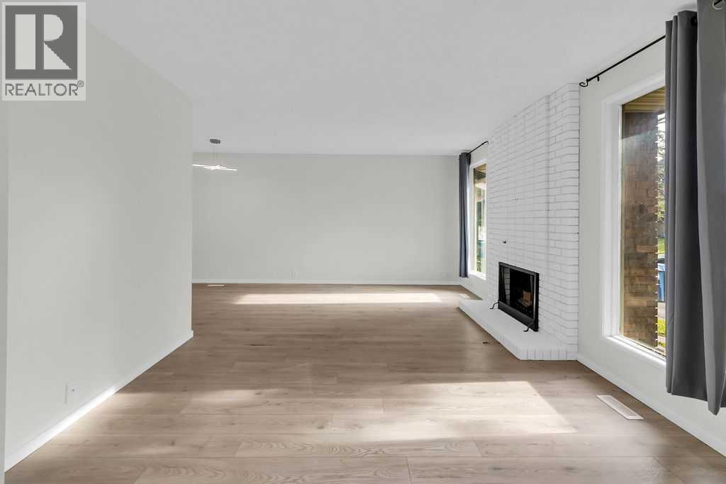 10 Radcliffe Crescent Se, Calgary, AB - Indoor Photo Showing Other Room With Fireplace