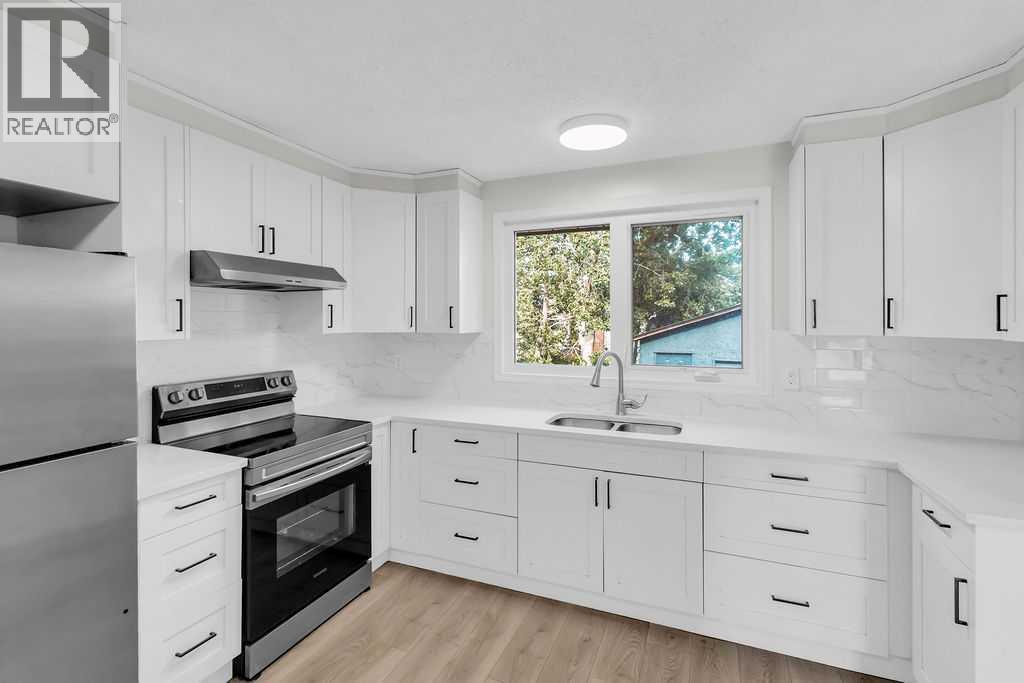 10 Radcliffe Crescent Se, Calgary, AB - Indoor Photo Showing Kitchen With Double Sink