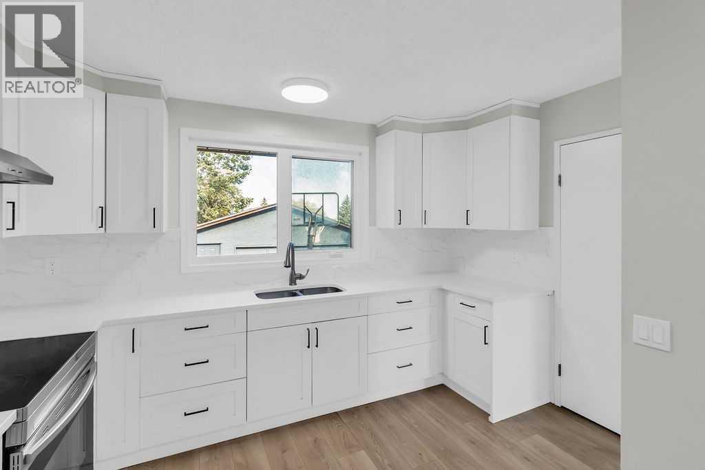 10 Radcliffe Crescent Se, Calgary, AB - Indoor Photo Showing Kitchen With Double Sink