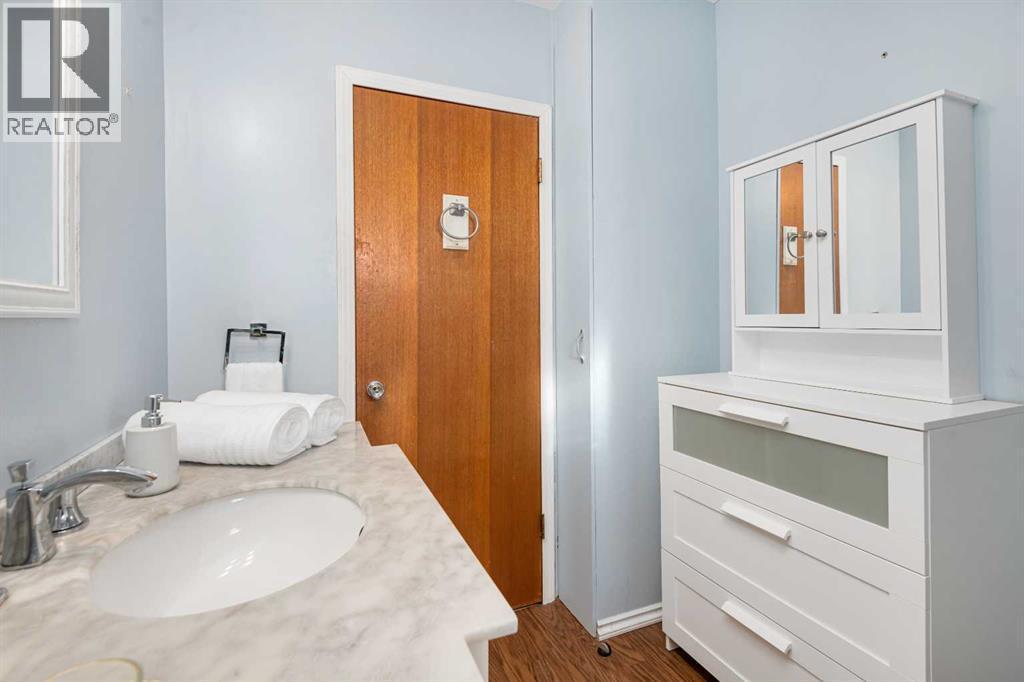 Extra Storage Vanity and Hidden Closet behind the door - 1423 18A Street Ne, Calgary, AB - Indoor Photo Showing Other Room