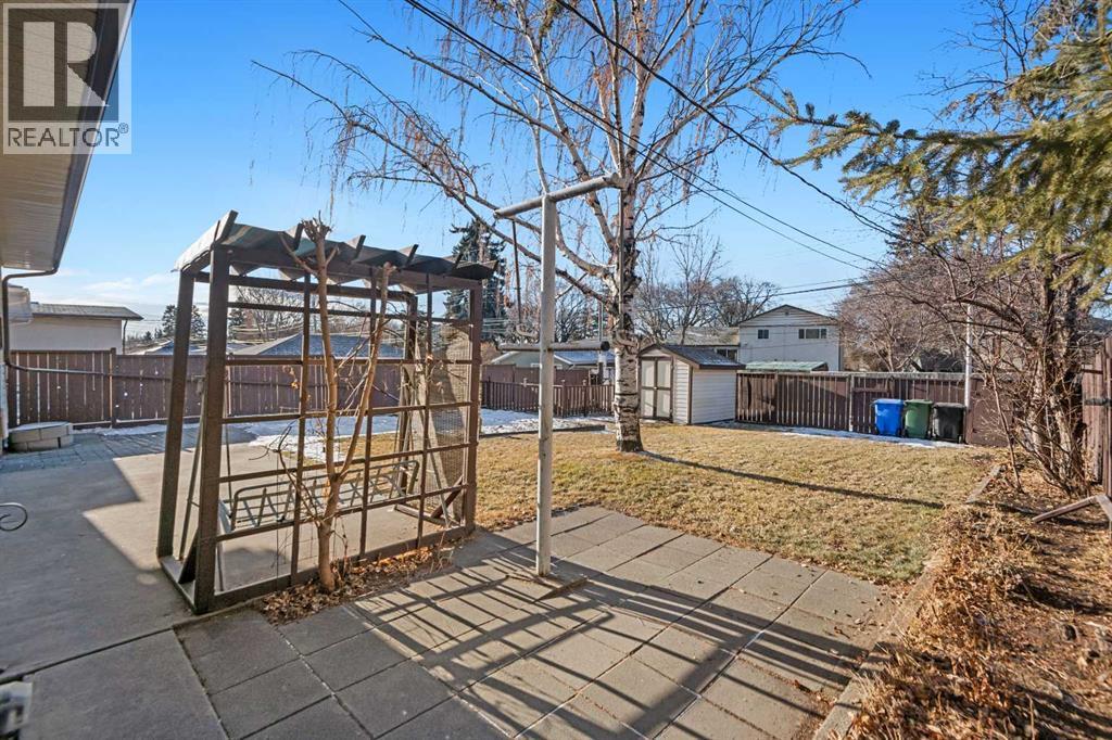 Small Pergola with Swing to enjoy the beautiful backyard. Functioning Clothesline - 1423 18A Street Ne, Calgary, AB - Outdoor