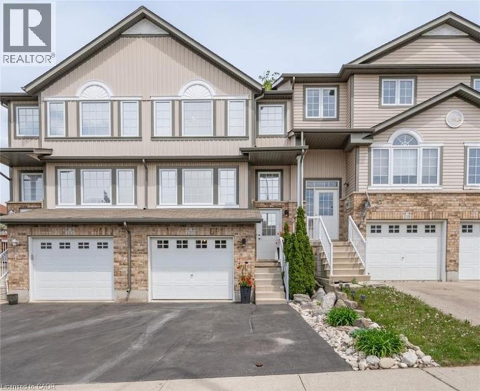 View of front of home with an attached garage and driveway - 220 Snowdrop Crescent, Kitchener, ON - Outdoor With Facade