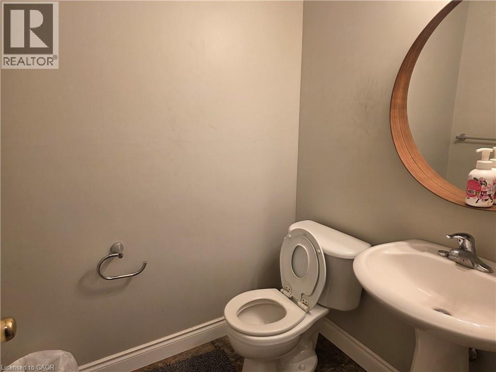 Half bath with toilet and baseboards - 220 Snowdrop Crescent, Kitchener, ON - Indoor Photo Showing Bathroom