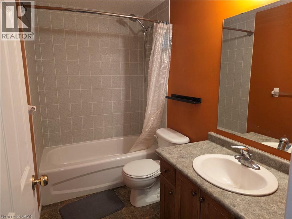 Full bath featuring vanity and shower / tub combo with curtain - 220 Snowdrop Crescent, Kitchener, ON - Indoor Photo Showing Bathroom