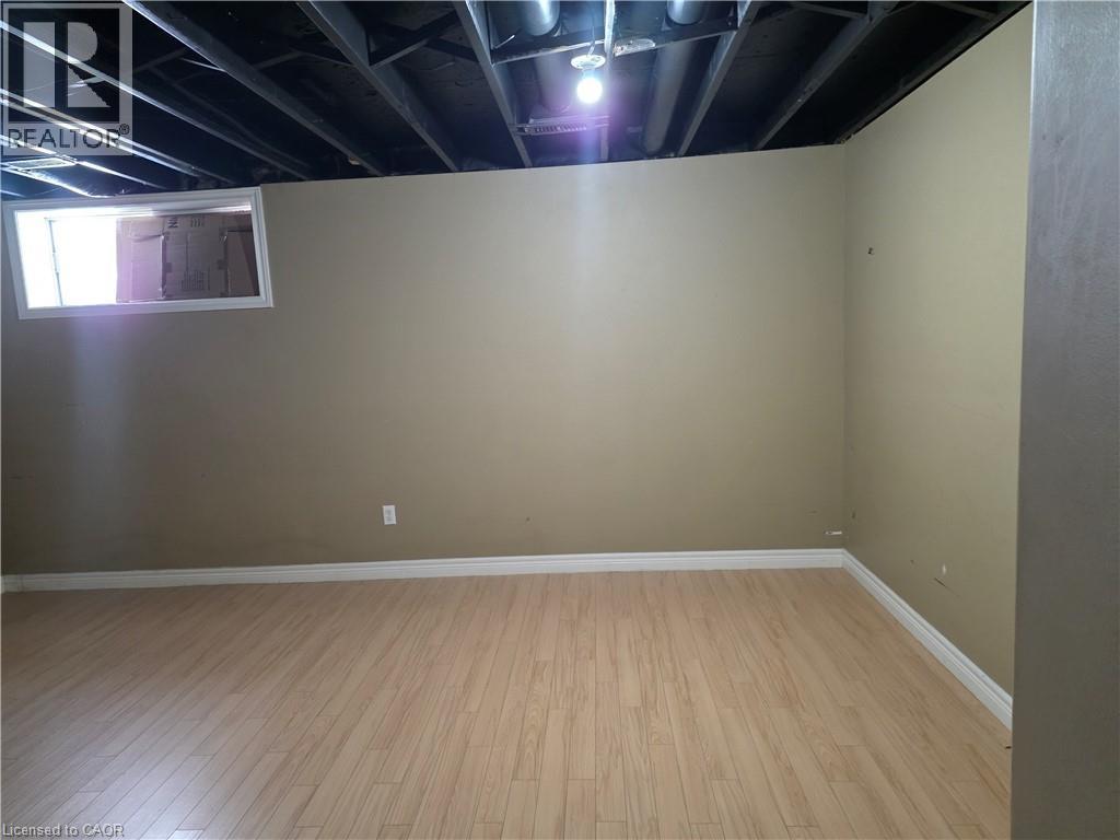Below grade area featuring light wood-style floors and baseboards - 220 Snowdrop Crescent, Kitchener, ON - Indoor Photo Showing Other Room