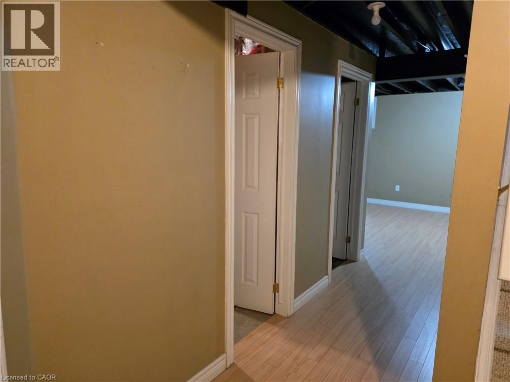 Corridor featuring baseboards and light wood-type flooring - 220 Snowdrop Crescent, Kitchener, ON - Indoor Photo Showing Other Room