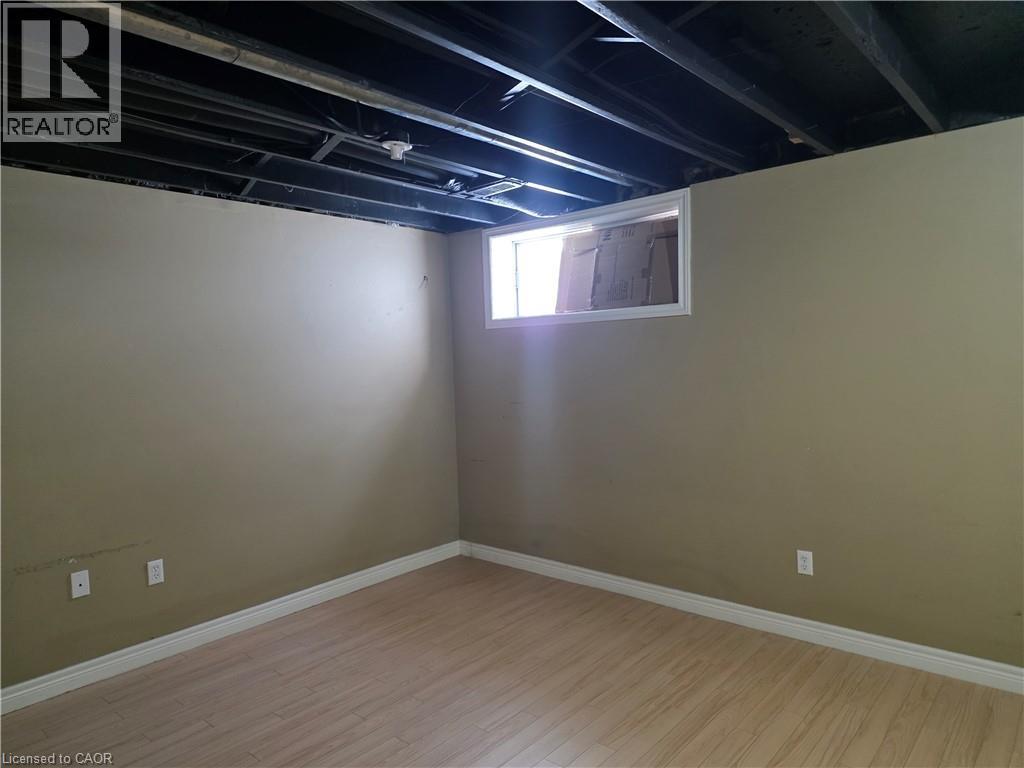 Below grade area featuring light wood-type flooring and baseboards - 220 Snowdrop Crescent, Kitchener, ON - Indoor Photo Showing Other Room