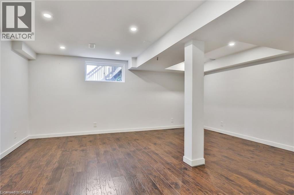 Below grade area with dark wood-style flooring and recessed lighting - 42 Madonna Drive, Hamilton, ON - Indoor