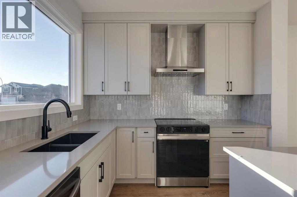 367 Fireside Drive, Cochrane, AB - Indoor Photo Showing Kitchen With Double Sink With Upgraded Kitchen