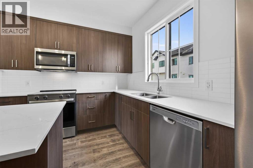 Kitchen - 64 Creekside Drive Sw, Calgary, AB - Indoor Photo Showing Kitchen With Stainless Steel Kitchen With Double Sink With Upgraded Kitchen