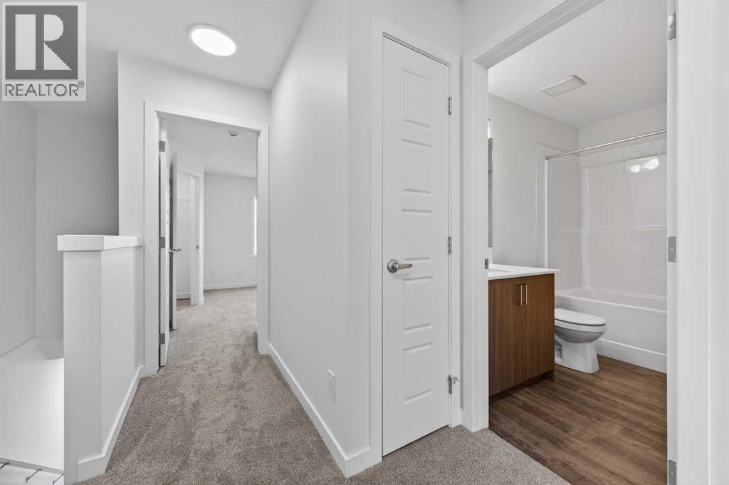 Upstairs hallway - 64 Creekside Drive Sw, Calgary, AB - Indoor Photo Showing Other Room