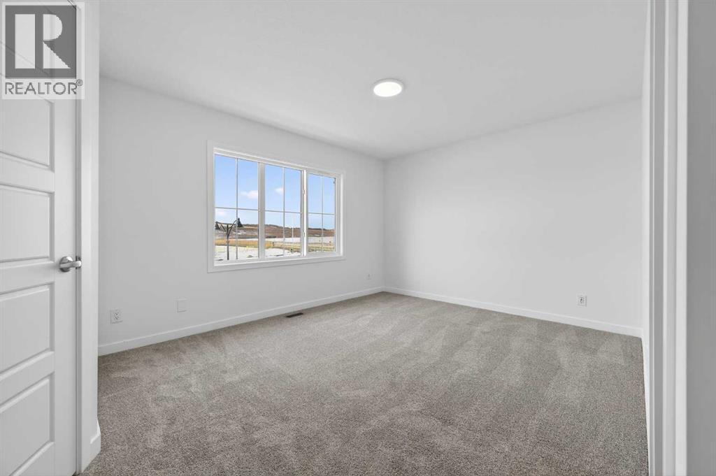Primary bedroom - 64 Creekside Drive Sw, Calgary, AB - Indoor Photo Showing Other Room