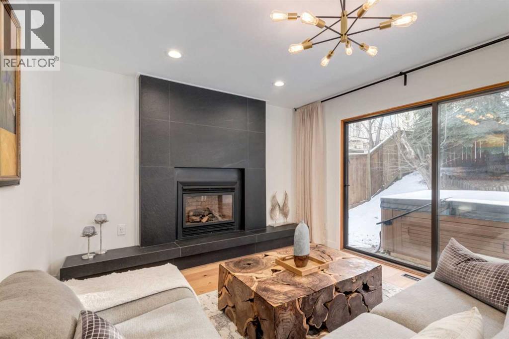 113 Straddock Terrace Sw, Calgary, AB - Indoor Photo Showing Living Room With Fireplace