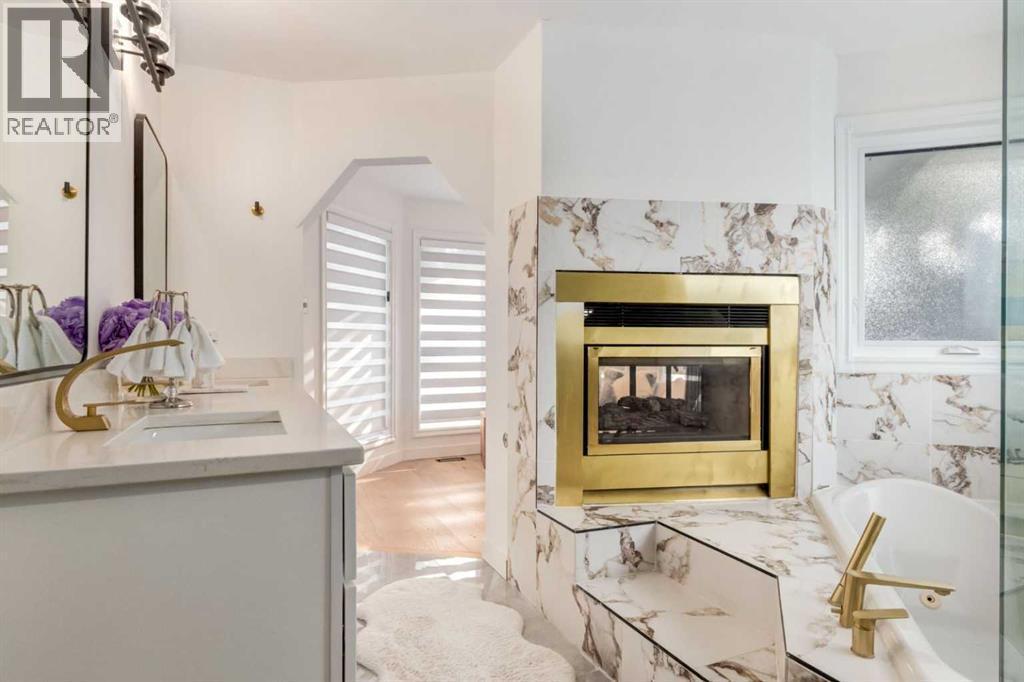 113 Straddock Terrace Sw, Calgary, AB - Indoor Photo Showing Living Room With Fireplace