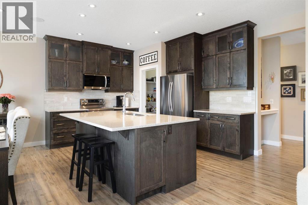 8 Emberside Glen, Cochrane, AB - Indoor Photo Showing Kitchen With Stainless Steel Kitchen With Upgraded Kitchen