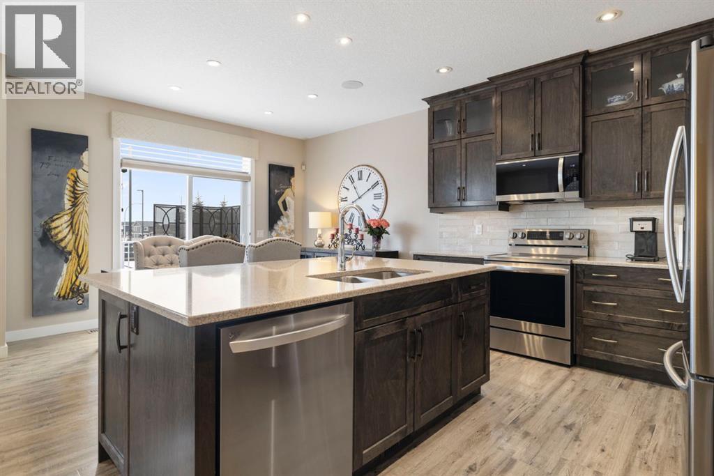 8 Emberside Glen, Cochrane, AB - Indoor Photo Showing Kitchen With Stainless Steel Kitchen With Double Sink With Upgraded Kitchen
