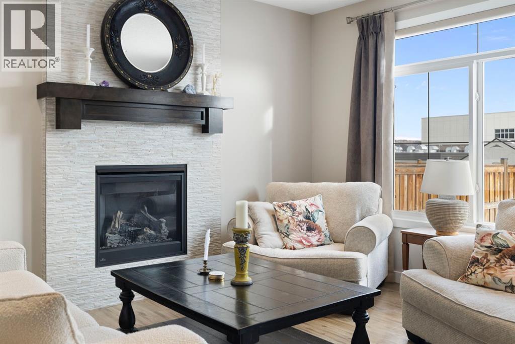 8 Emberside Glen, Cochrane, AB - Indoor Photo Showing Living Room With Fireplace