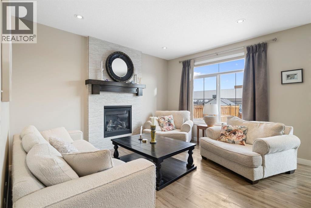 8 Emberside Glen, Cochrane, AB - Indoor Photo Showing Living Room With Fireplace