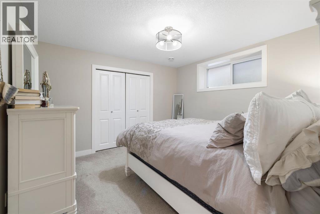 8 Emberside Glen, Cochrane, AB - Indoor Photo Showing Bedroom