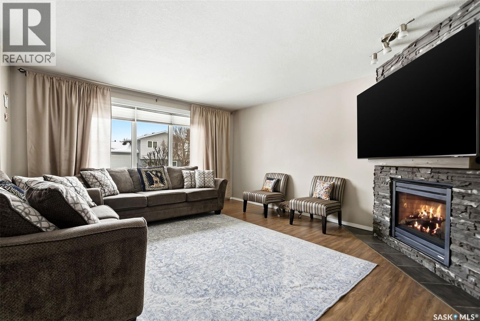 2778 Schweitzer Drive, Regina, SK - Indoor Photo Showing Living Room With Fireplace