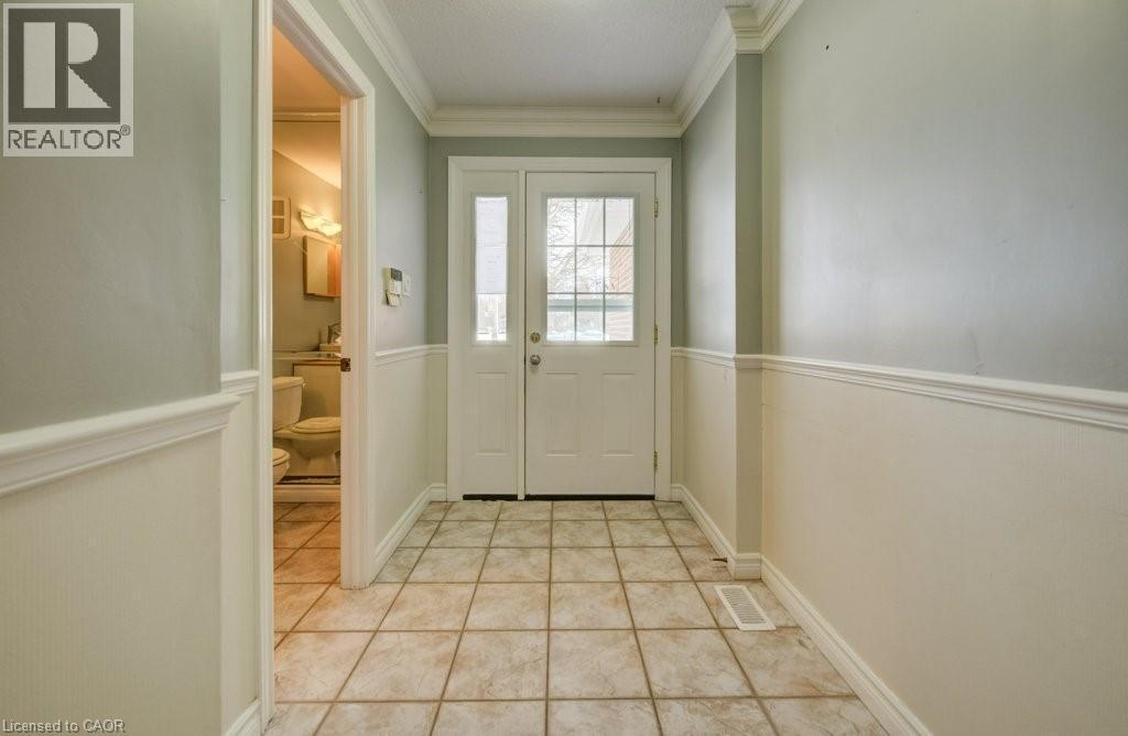 Entryway featuring ornamental molding and tile patterned floors - 54 Nicklaus Drive, Hamilton, ON - Indoor Photo Showing Other Room
