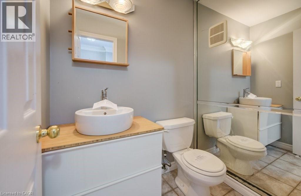 Bathroom with vanity and tile patterned floors - 54 Nicklaus Drive, Hamilton, ON - Indoor Photo Showing Bathroom