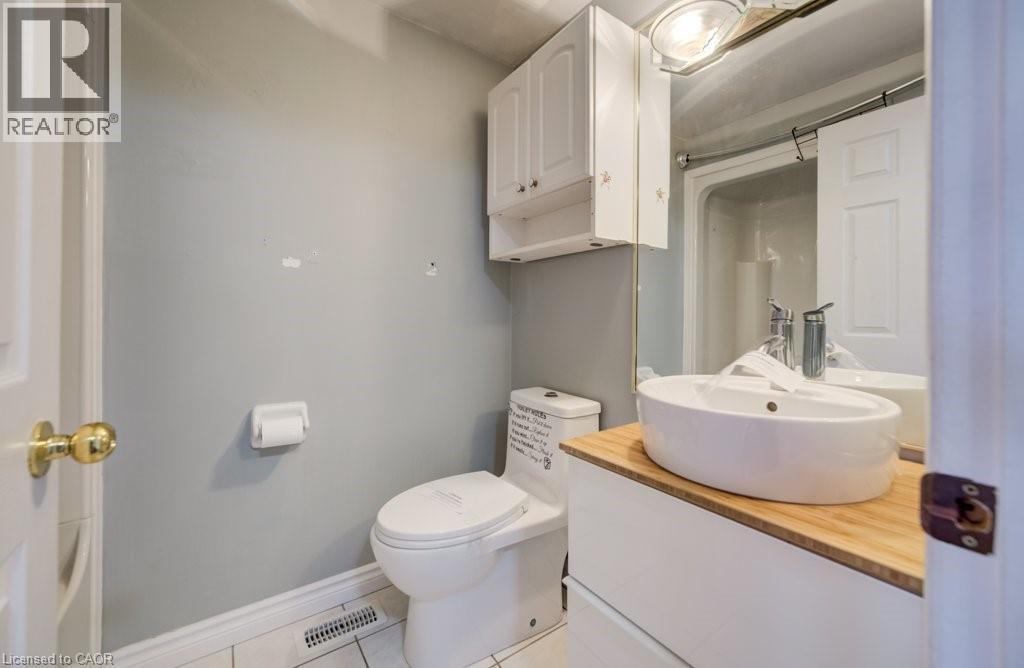 Full bath featuring vanity, light tile patterned floors, and a shower - 54 Nicklaus Drive, Hamilton, ON - Indoor Photo Showing Bathroom