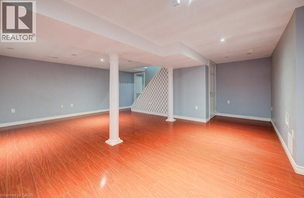 Finished below grade area with light wood finished floors and recessed lighting - 54 Nicklaus Drive, Hamilton, ON - Indoor Photo Showing Other Room