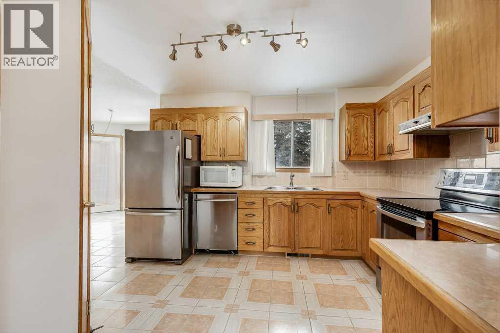 Kitchen - 106 Sienna Hills Drive Sw, Calgary, AB - Indoor Photo Showing Kitchen With Stainless Steel Kitchen With Double Sink