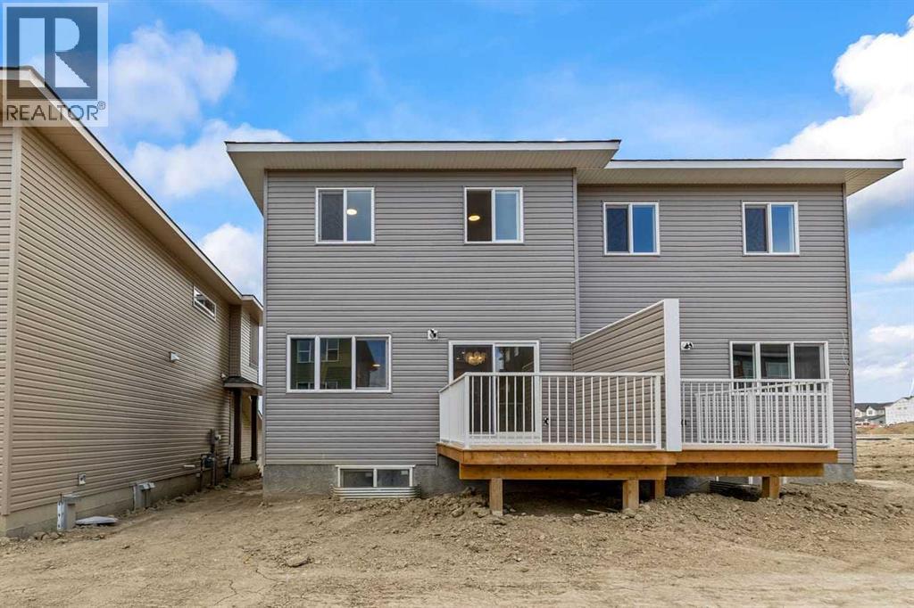 90 Heritage Circle, Cochrane, AB - Outdoor With Deck Patio Veranda With Exterior