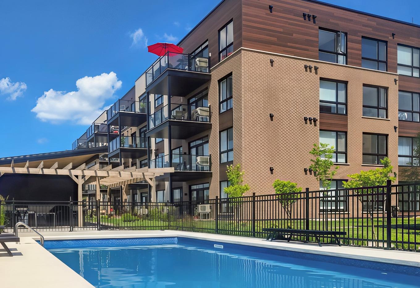 Back facade - 206-3660 Rue Roland-Marquette, Longueuil (Saint-Hubert), QC - Outdoor With In Ground Pool