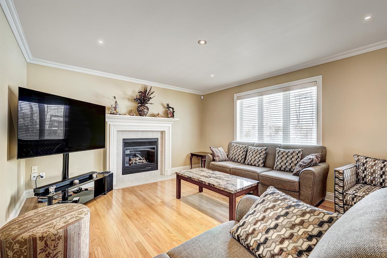 Family room - 24 Rue Du Syrah, Kirkland, QC - Indoor Photo Showing Living Room With Fireplace