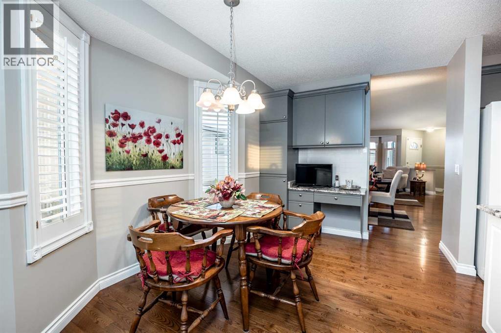 Nook / kitchen - 509 Highview Point Nw, High River, AB - Indoor Photo Showing Dining Room With Fireplace