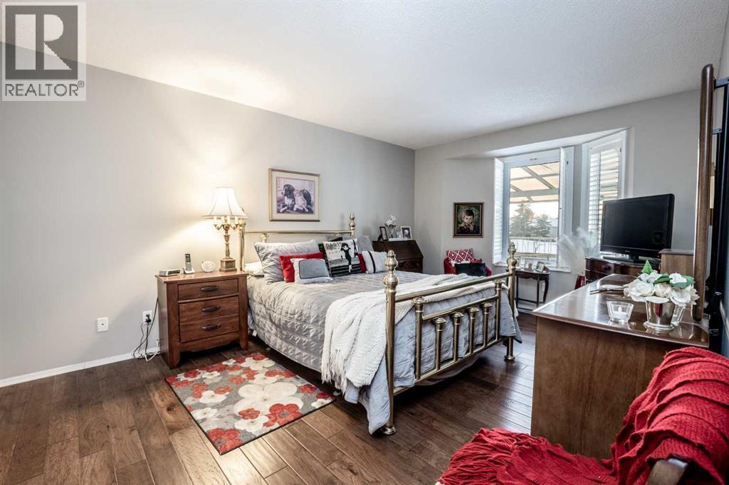 Master bedroom - 509 Highview Point Nw, High River, AB - Indoor Photo Showing Bedroom