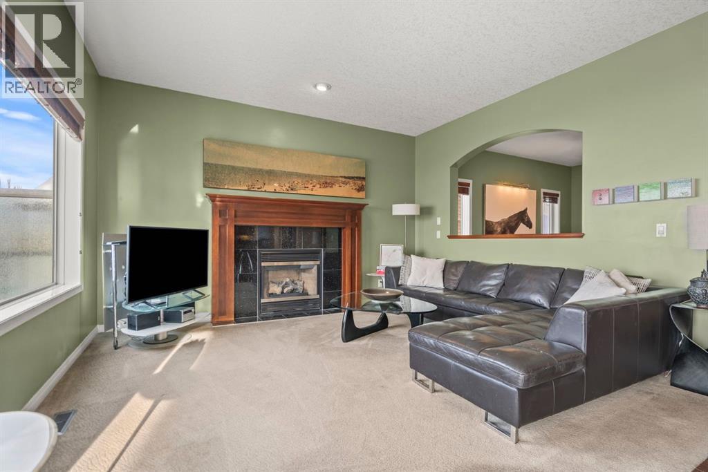 153 Crestridge Way Sw, Calgary, AB - Indoor Photo Showing Living Room With Fireplace