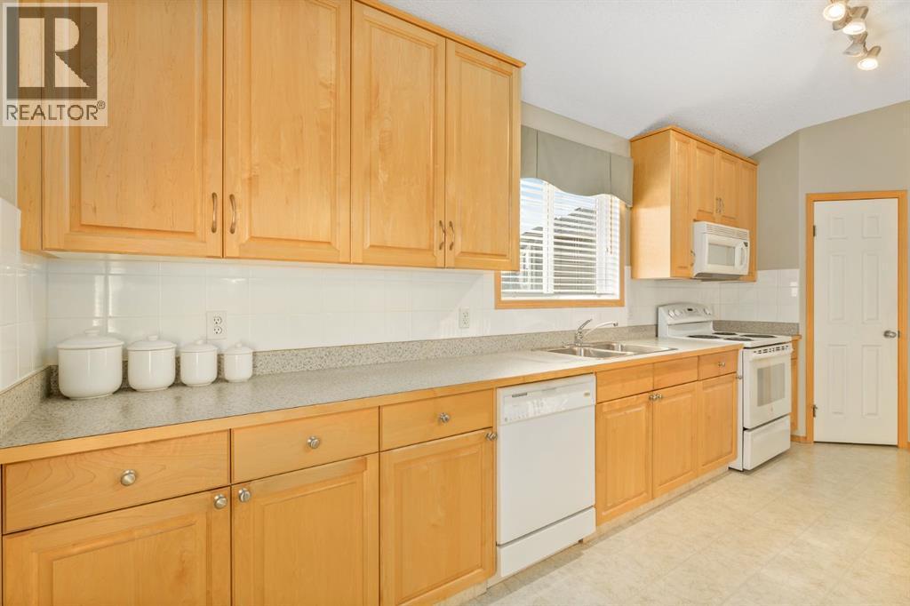 131 Panatella Close Nw, Calgary, AB - Indoor Photo Showing Kitchen With Double Sink