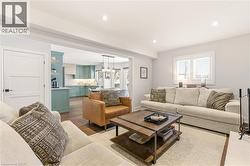 Living area with dark wood finished floors and recessed lighting -